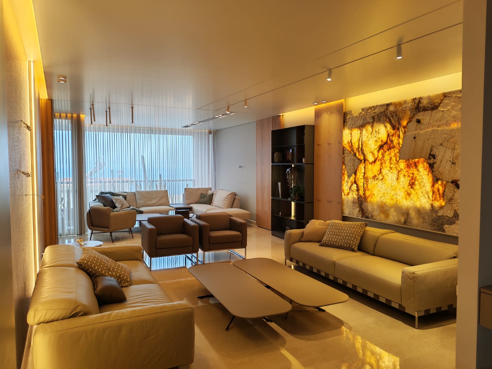 Living room by Continuum Design & Contracting with a backlit onyx feature wall